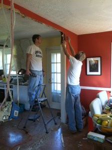 men doing man stuff, like cutting out wallboard